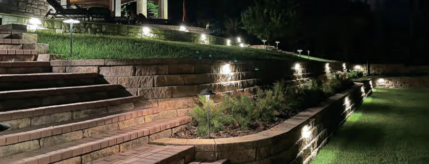 Pathway and hardscape lighting illuminating garden steps and a retaining wall